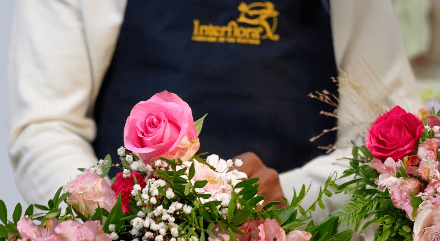 Florist Holding a Bouquet with Interflora Logo Represented